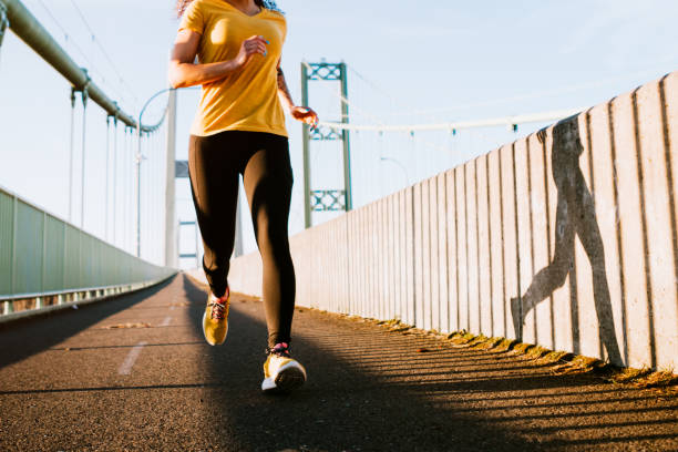 istock Young Woman on Morning Run in Urban Setting 920027228