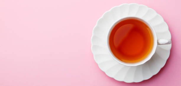 istock Cup of tea on pink background. Top view. Copy space 920027656