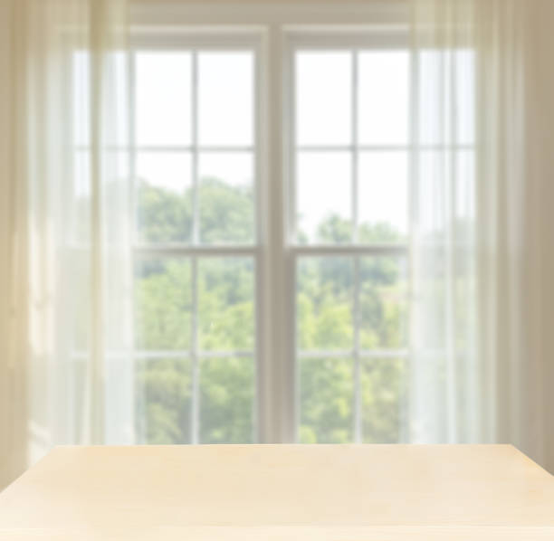 istock Wooden desk in front of window with space for composites 920027806