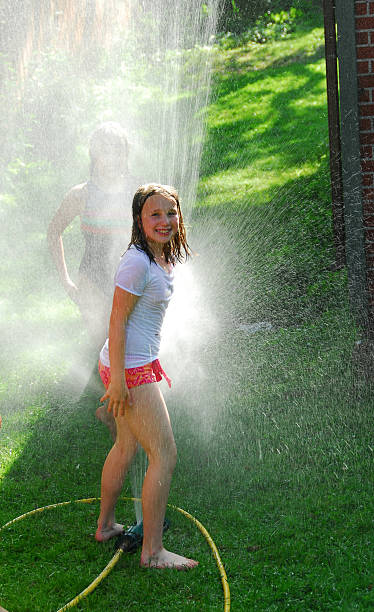 istock Girls and sprinkler 92002904