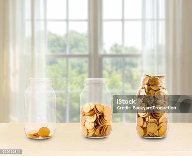 Three Glass Jars Of Growing Savings On Shelf Stock Photo - Download Image Now - Coin, Gold - Metal, Jar