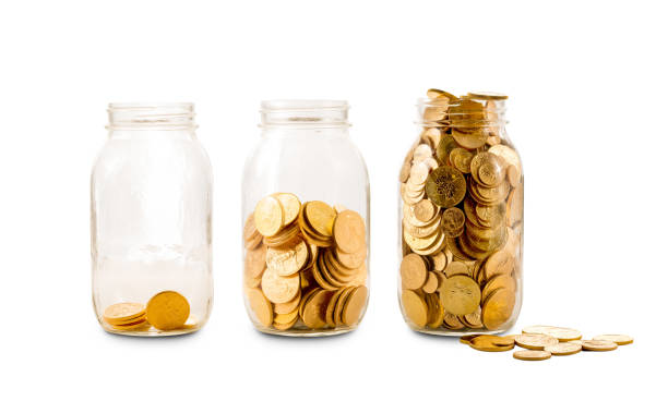 istock Many gold coins in three glass bottles 920029880