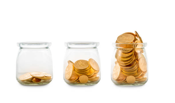istock Many gold coins in three glass bottles 920029904