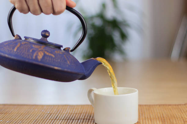 istock Blue Chinese cast iron teapot. The process of brewing tea. 920030408