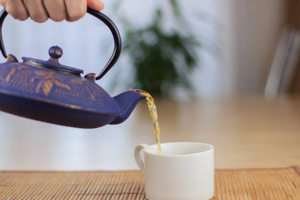 istock Blue Chinese cast iron teapot. The process of brewing tea. 920030414