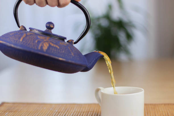 istock Blue Chinese cast iron teapot. The process of brewing tea. 920030422