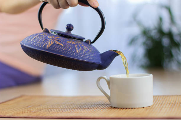 istock Blue Chinese cast iron teapot. The process of brewing tea. 920030426