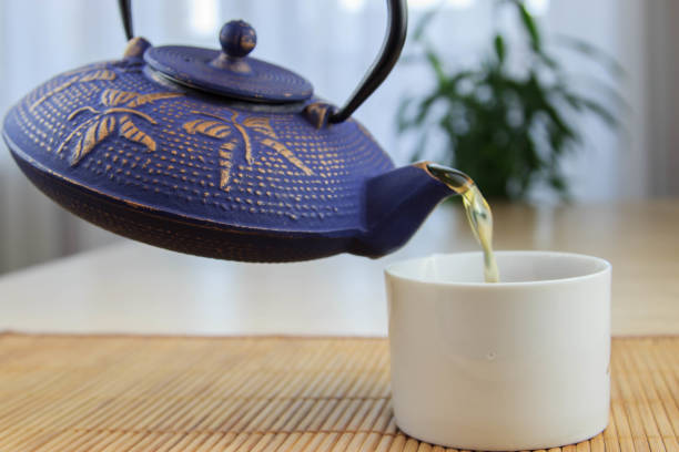 istock Blue Chinese cast iron teapot. The process of brewing tea. 920030464