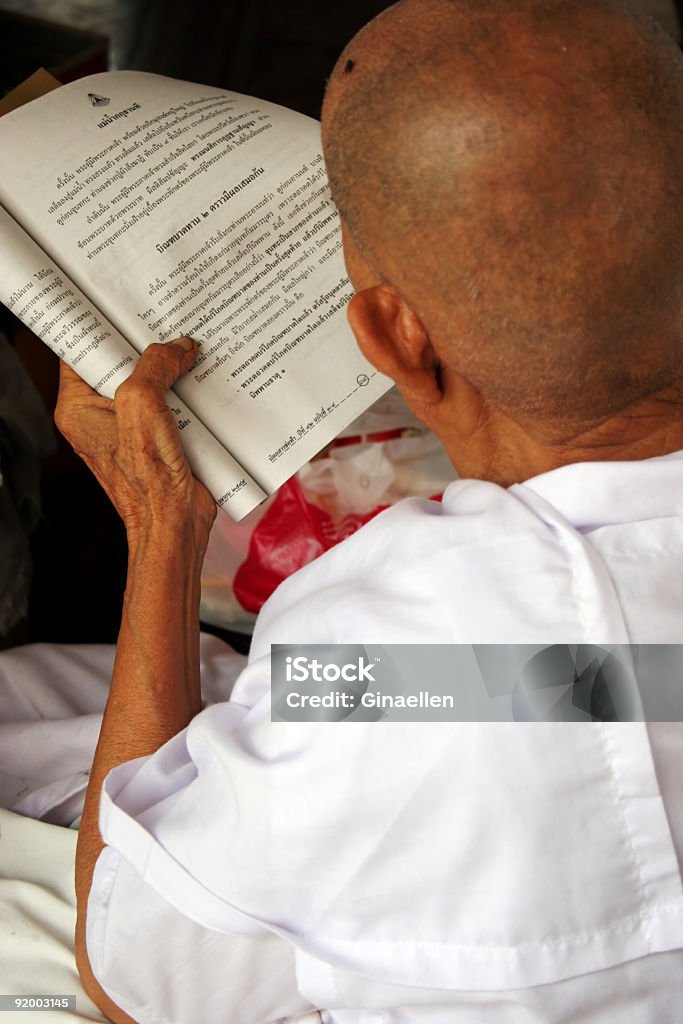 Reading religious words Old Buddhist monk reading religious text (focus on text), Bangkok, Thailand Active Seniors Stock Photo