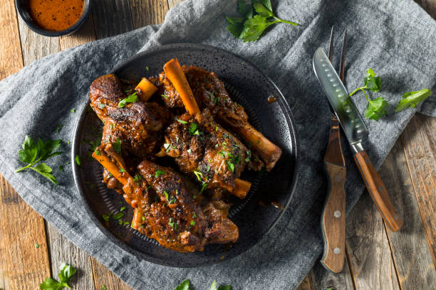Homemade Braised Lamb Shanks Homemade Braised Lamb Shanks with Sauce and Herbs lamb meat stock pictures, royalty-free photos & images