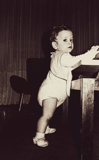 istock Vintage black and white baby boy standing 920033588