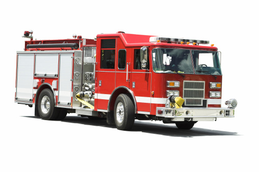 Child, cute boy, dressed in fire fighters cloths in a fire station with fire truck, Childs' dream