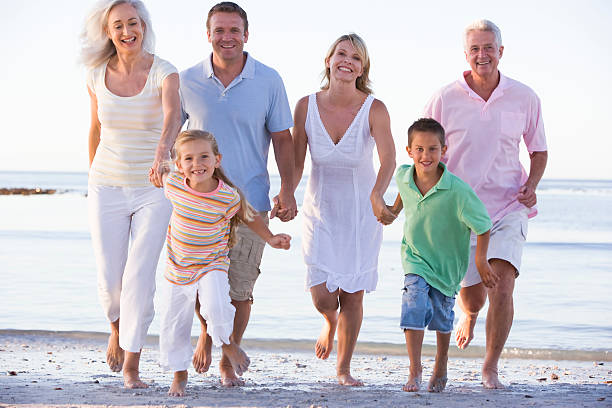 istock Extended family walking on beach 92003633
