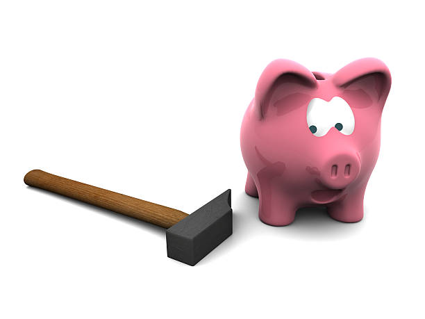 piggy bank with hammer stock photo