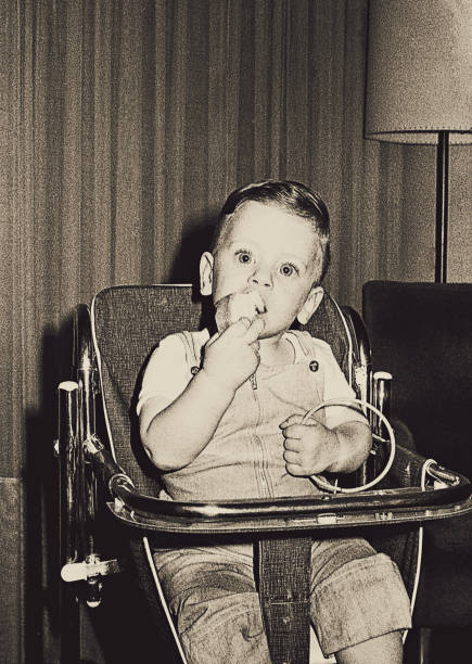 istock Vintage black and white baby boy eating 920038158