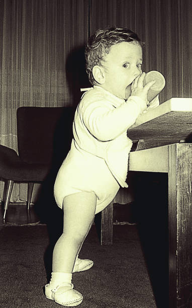 istock Vintage black and white baby boy drinking water 920038422