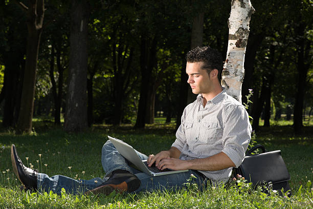 istock young businessman working in a park 92003873