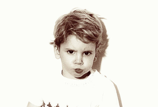 vintage grainy black and white kid making faces - 20th century style flash imagens e fotografias de stock