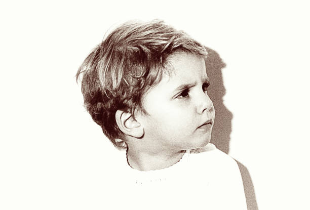 vintage grainy black and white kid looking angry - 20th century style flash imagens e fotografias de stock