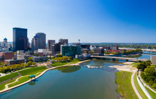 Dayton Aerial With River And Bridge Downtown Dayton skyline aerial view with a bridge on the right, and with the Great Miami River in the foreground. dayton ohio skyline stock pictures, royalty-free photos & images