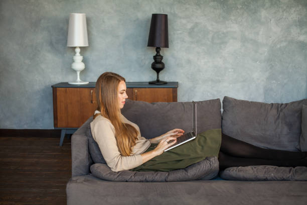 istock Young Woman Resting with Laptop at Home 920041318