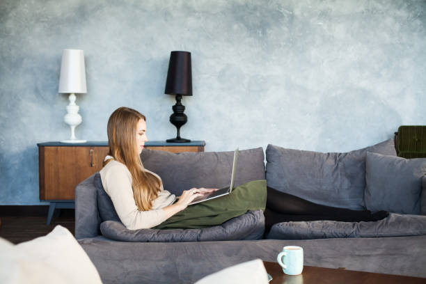 istock Young Woman Using Laptop at Home 920041536