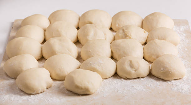 istock Ball-shaped pieces of dough prepared for pies making 920044608