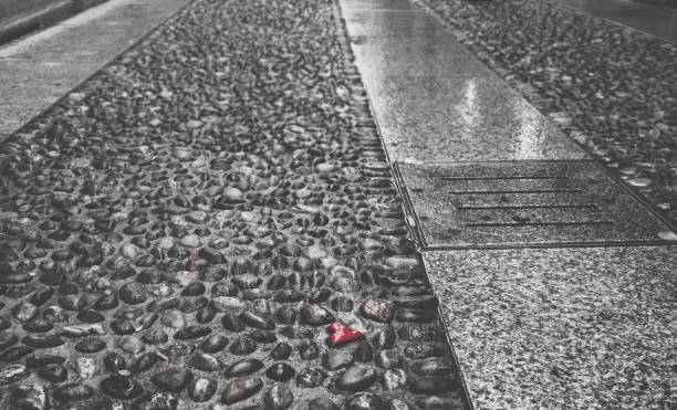 istock Selective color of heart shaped pebble on pedestrian sidewalk 920045024