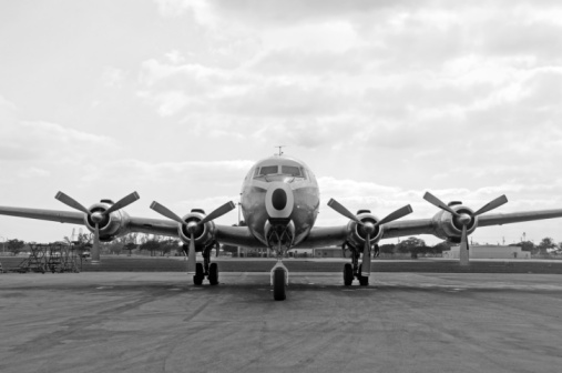 Vintage Douglas DC-3 propellor airplane ready for take off at the runway of an empty airfield. Image with a retro look.