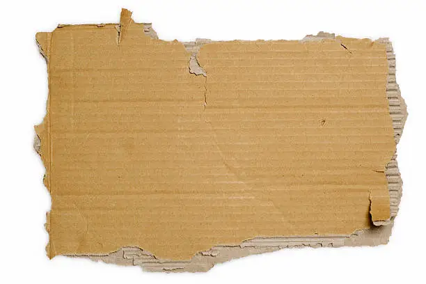 Photo of White background with a brown torn piece of cardboard