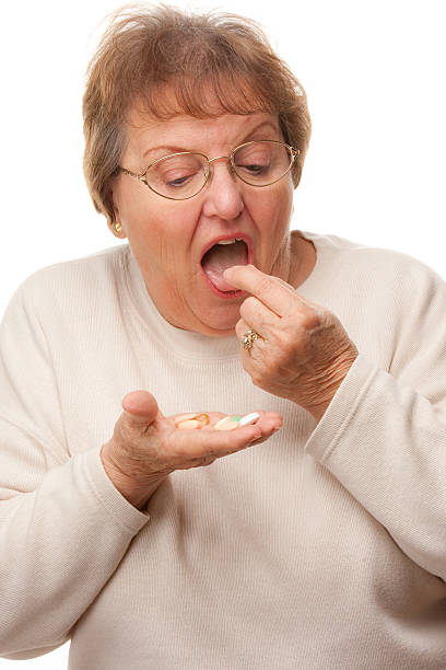 istock Attractive Senior Woman Taking Pills 92004904