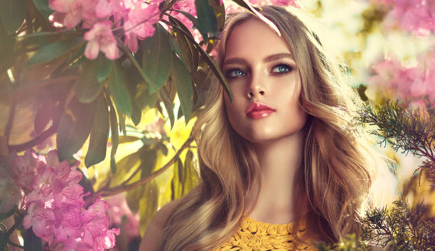 beautiful young model in a spring blossoming garden. symbol of blooming youth. - women beauty innocence make up imagens e fotografias de stock