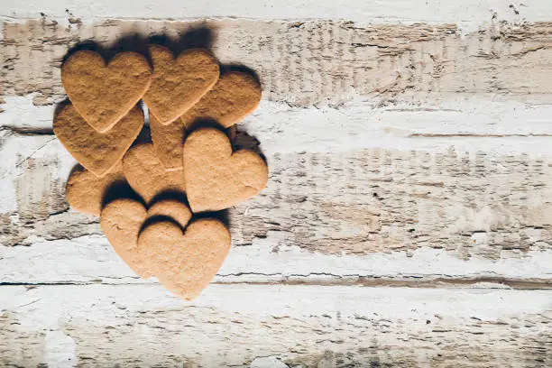 cookie hearts with place for text on wooden background, toned