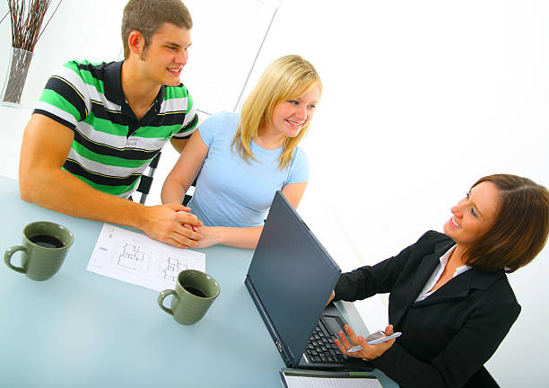 istock Happy Couple Discussing With Real Estate Broker 92006490