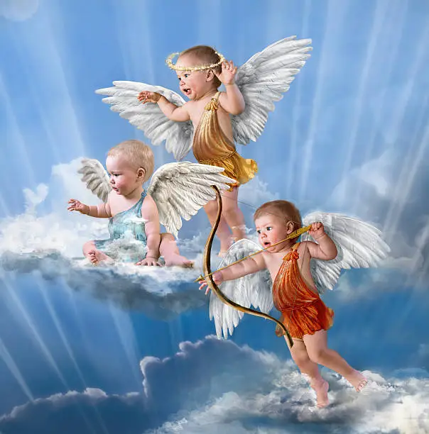 Photo of Babies dressed as cherubs on background of bright clouds