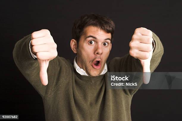 A Man Putting His Thumbs Down In A Disapproving Manner Stock Photo - Download Image Now