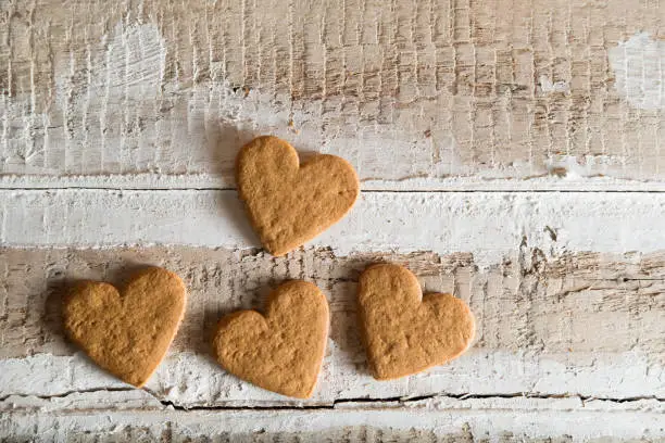 cookie hearts with place for text on wooden background, toned
