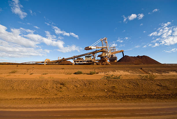 Reclaimer Stacker on Iron Ore Mine Site  Reclaimer stock pictures, royalty-free photos & images