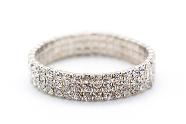 Silver bracelet with black gems on satin dark background