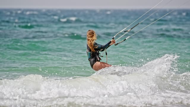 SLO MO Woman kiteboarding on a windy day