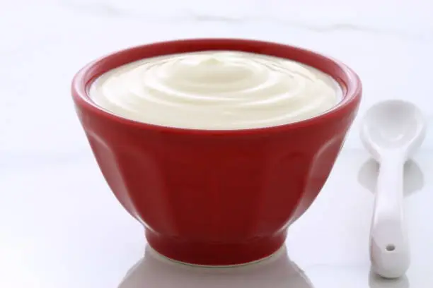 Delicious, nutritious and healthy fresh plain yogurt on vintage italian carrara marble setting.