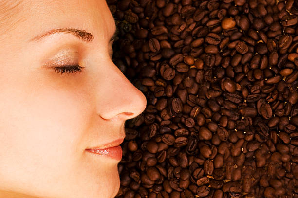 Beautiful girl's face on over coffee bean background