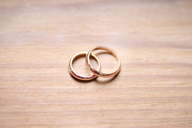 istock wedding rings on wooden background 920126006