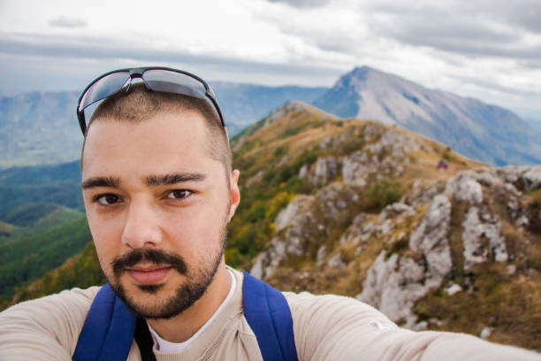 istock Young man on top of the mountain making selfie. 920126186