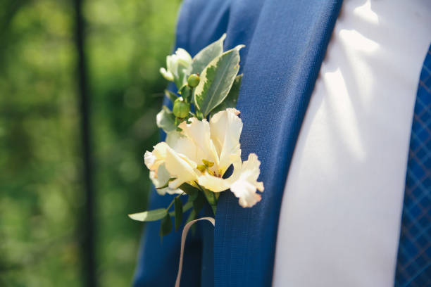 istock Groom in a suit holding buttonhole 920126364
