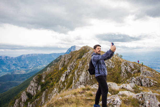 istock Young man on top of the mountain making selfie. 920128516