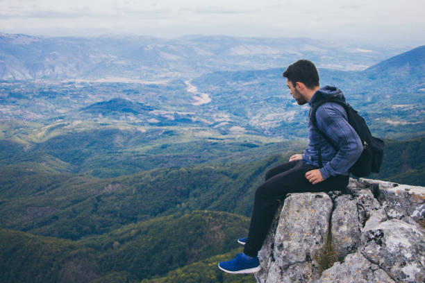 istock Young man on on high cliff. Mountain view. 920128838