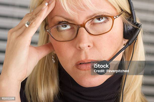 Businesswoman With Phone Headset And Headache Stock Photo - Download Image Now - Hotel Reception, Receptionist, Using Phone