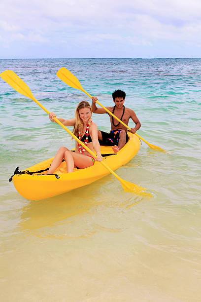 istock young couple paddle a kayak in Hawaii 92013612