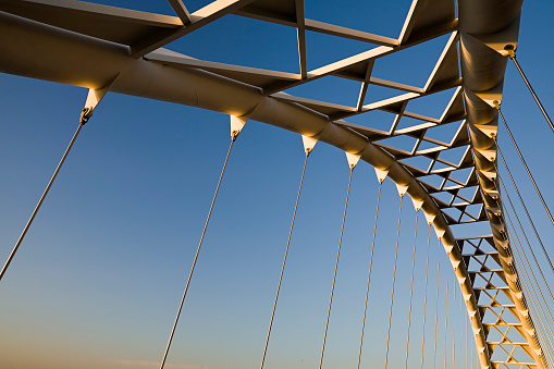 Metal steel railway bridge against the blue sky